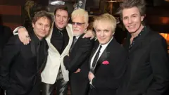 Getty Images Price with Duran Duran at their 70th birthday party in London in 2015.