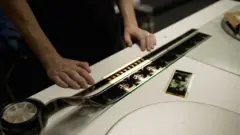 Two strips of film side by side showing the IMAX 70mm is at least twice the height of standard 35mm film
