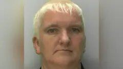 Gloucestershire Constabulary mug shot of Amanda Wixon. She has short, blonde hair.