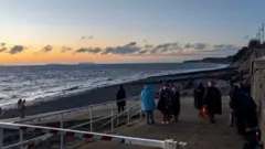 Nadezna/BBC Weather watchers gather to watch the sunrise on Christmas Day in Penarth