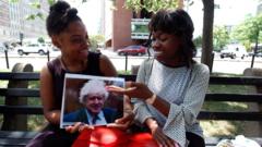 Two Americans holding a photo of Boris