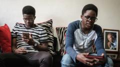 Kenyan boys looking at their phones