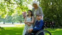 Queen Camilla hosts boy who missed garden party