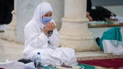 A Muslim pilgrim wears a mask as she prays inside the Namira Mosque in Arafat to mark the Hajj"s most important day, Day of Arafat (30 July 2020)