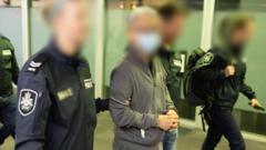 Australian police escort a handcuffed Tse Chi Lop through Melbourne airport on Thursday 22/12