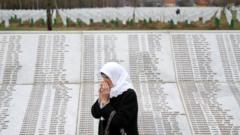A woman is seen near a family grave at the Memorial centre Potocari near Srebrenica, Bosnia and Herzegovina on 20 March 2019