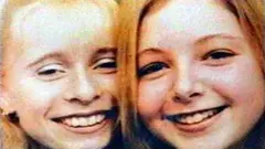A close-up picture of the faces of a young Victoria Hall and her friend Gemma Algar. They are both close together and smiling into the camera. They seem happy.