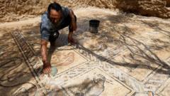 Salman al-Nabahin cleaning the mosaic floor discovered on his farm in Gaza