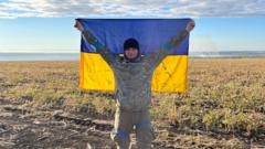 Oleksandr holding a Ukrainian flag