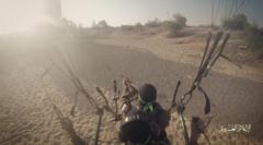 Un combatiente aterrizando en paracaídas motorizado al inicio del asalto contra Israel