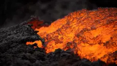 Orange lava flows next to charcoal rocks