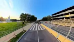 Fisheye view of a road with US Capitol on the left side.