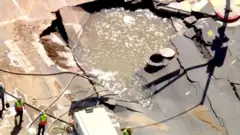 A sinkhole filled with water in West Hollywood.