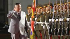Kim Jong-un salutes as he walks past troops, Pyongyang (10 Oct)
