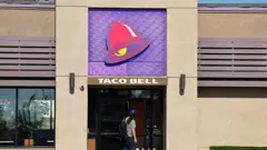  A person enters a Taco Bell restaurant on July 14, 2026 in Pasadena, California.