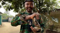 Professor Edem Archibong Eniag hold snake for hand
