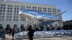 A giant inflatable whale floats in the Murmansk center as part of an art installation