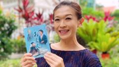 Singaporean TV fan Kit Ow holding Oshin DVD