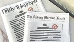 Copies of The Daily Telegraph and The Sydney Morning Herald newspapers feature blacked-out text