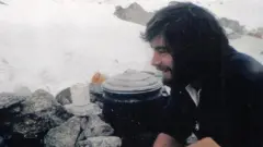 Mike Thexton An old photo of Pete Thexton smiling in front of a camp stove