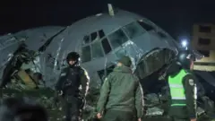 Members of the Bolivian Armed Forces guard the wreckage of the plane