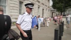 Moment Met Police chief appears to push past journalist’s microphone