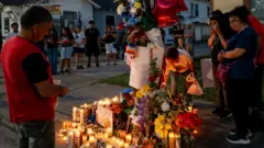 Family members of Mexican immigrant Lorenzo Salgado Araujo grieve at a makeshift memorial.