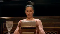 Rachel opening her chest of chance at the roundtable and looking inside