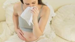 Pregnant woman using a tissue