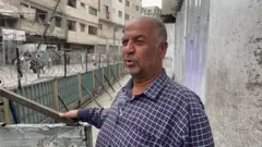 Abu Alao Jaffar outside a closed bakery in Gaza, Northern Gaza
