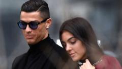 Juventus' forward and former Real Madrid player Cristiano Ronaldo leaves with his Spanish girlfriend Georgina Rodriguez