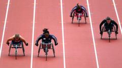 Anne Wafula Strike racing in a wheelchair against three competitors