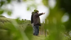 GMP Amr Hussein gestures away from the camera while Walid Saadaoui stands behind him in Dover, Kent