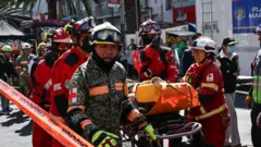Members of government rescue institutions aid a participant during an earthquake drill in Mexico City.