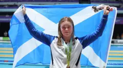 Katie Shanahan with a bronze medal and Scotland flag at Birmingham 2022