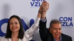 Juan Barreto/AFP via Getty Images Venezuelan opposition leader Maria Corina Machado shakes hands with opposition presidential candidate Edmundo Gonzalez Urrutia in Caracas, July 29, 2024, a day after Venezuela's presidential election. P