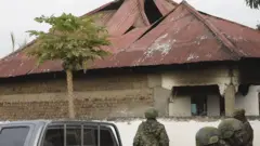 Getty Images Uganda security forces at the Mpondwe Lhubiriha Secondary School on 17 June