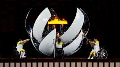 The Paralympic flame is lit by, from left, Shunsuke Uchida, Yui Kamiji and Karin Morisaki during the Opening Ceremony of the Tokyo 2020 Paralympic Games at the Olympic Stadium in Tokyo, Japan.
