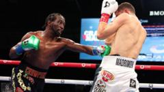 Crawford beats Madrimov to become four-weight world champion