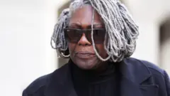 Janice Nix leaving the Old Bailey, wearing a black coat and sunglasses