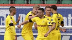 Dortmund players celebrate Guerreiro's goal