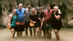 Group standing in water smiling