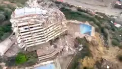 A partly collapsed building from above.