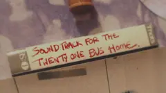 The mixtape has been positioned on top of a sideboard. On the side of the tape, written in red pen, the label reads: