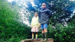 Jayden and Angel stood together on a tree stump