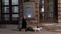 A woman walks her dog during a curfew imposed to prevent the spread of coronavirus disease in Belgrade