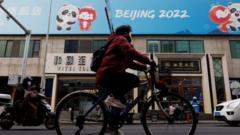 A person cycles past a Beijing 2022 sign