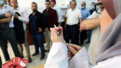 Palestinians men arrive to receive a jab of the Pfize vaccine against Covid-19, at the Palestinian Medical centre in the West Bank city of Hebron, 27 May 2021
