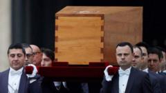 Pall bearers cari di coffin of former Pope Benedict from di basilica 