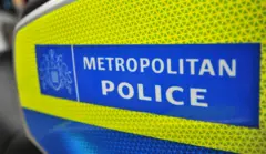 Close-up image of the Metropolitan Police logo, which has white lettering on a blue background and yellow border.